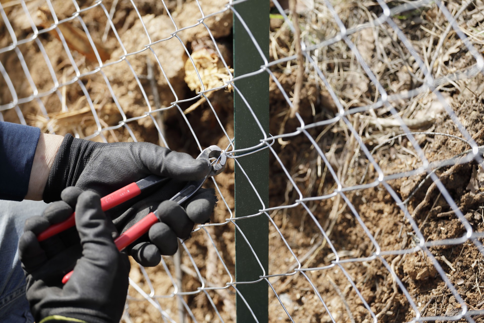 Construction worker building a fence